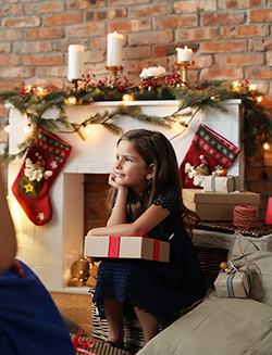 picture of a girl holding a christmas gift